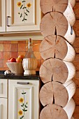 Interior wall of log cabin next to kitchen counter