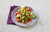 Avocado with tomatoes, almonds and pine nuts