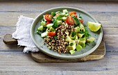 A colourful quinoa salad with avocado, tomatoes and cucumber