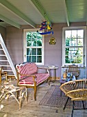 Bench with red and white striped upholstery and wicker chair in rustic living room