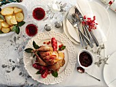 Roast pheasant wrapped in bacon with pomegranate seeds and potatoes for Christmas