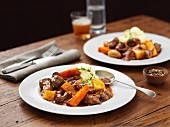 Lamb stew with mashed potatoes, carrots and beer