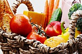 Vegetables, fruit, cheese and baguette in a basket