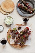 Beef kebabs with peppers, tzatziki and unleavened bread