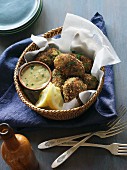 Crab cakes with a dip in a basket