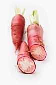 Red radishes on a white surface