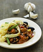 Mafaldine with a vegetable ragout and olives