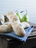 Two baguettes on a rustic table
