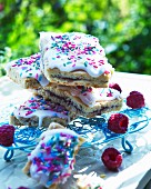 Cakes slices with raspberry jam and icing sugar