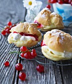Profiteroles filled with cream and redcurrants