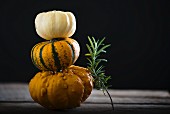 A stack of pumpkins with rosemary