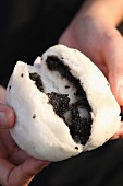 A steamed roll filled with black sesame paste