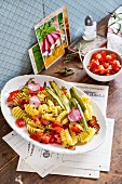 Pasta with tomatoes, asparagus and radishes