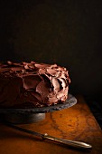 A chocolate cake on a slate cake stand