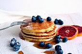 Buttermilk pancakes with maple syrup, blueberries and blood oranges