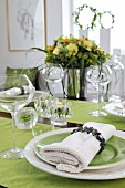 Festively set table - linen napkin on green plate and matching runners