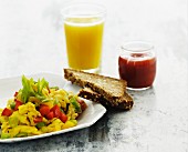 Scrambled eggs with vegetables, wholemeal bread and a glass or orange juice