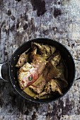 Fish curry in a pot (seen from above)