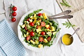 Avocado and mango salad with rocket and cherry tomatoes