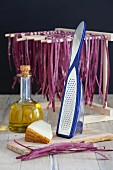 Beetroot pasta hung to dry with olive oil and cheese
