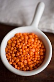 A bowl of red lentils (close-up)