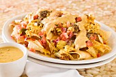 Breakfast nachos with egg, chorizo, tomatoes and melted cheese