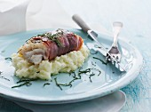 Cod fillet wrapped in smoked ham with sage on cauliflower purée