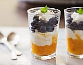 Two glasses of blueberry and mango parfait