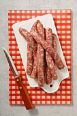 Fresh sausages on a chopping board