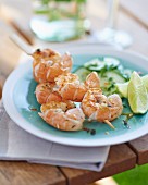 Grilled prawn skewers with a cucumber salad