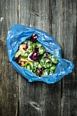 A dish of vegetables in a plastic bag