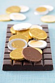 Chocolate coins and a bar of chocolate