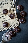 Nut biscuits with chocolate glaze and silver pearls