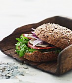 A wholemeal roll with rocket and smoked, rolled fillet of ham