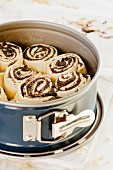 Poppyseed buns in a baking tin