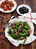 Rocket salad with beef and blackberries