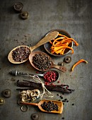 Various winter spices (cocoa bean splinters, orange zest, cinnamon flowers, pepper and vanilla)
