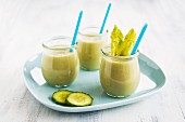 Vegetable smoothies in glasses with straws