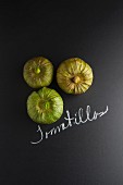 Three tomatillos with a label