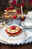 Pancakes with strawberries and icing sugar