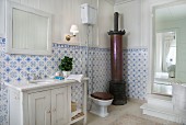 Traditional bathroom with cylindrical stove and blue and white wall tiles