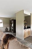 View across sofa to wooden base cabinet in masonry niche