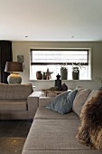 Grey sofa set in front of Christmas arrangement on windowsill