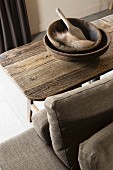 Wooden bowls, wooden paddle and piece of fur on rustic table