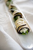 Aubergine rolls filled with goat's cheese and herbs