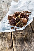 Various homemade chocolate pralines with grated chocolate and tissue paper