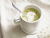 Cream of broccoli and potato soup with a dollop of cream and flaked almonds