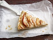 A slice of apple and quince tart on a cake slice