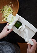 Courgette pasta being made with a spiral cutter (seen from above)
