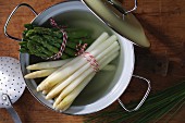 Boiled white and green asparagus in a pot